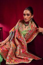 Woman wearing Pure Kashmiri Satin Handloom Banarasi Saree in pastel green with rich water zari weaving, temple border and floral Kashmiri design.